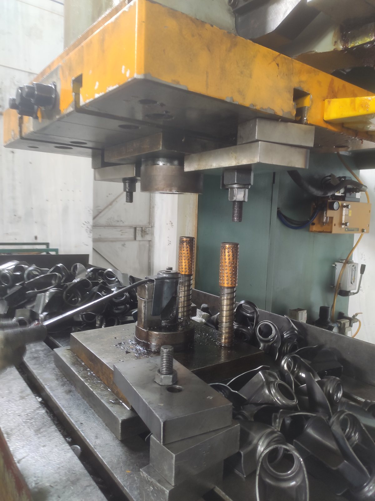 Castor bracket components at a forming station